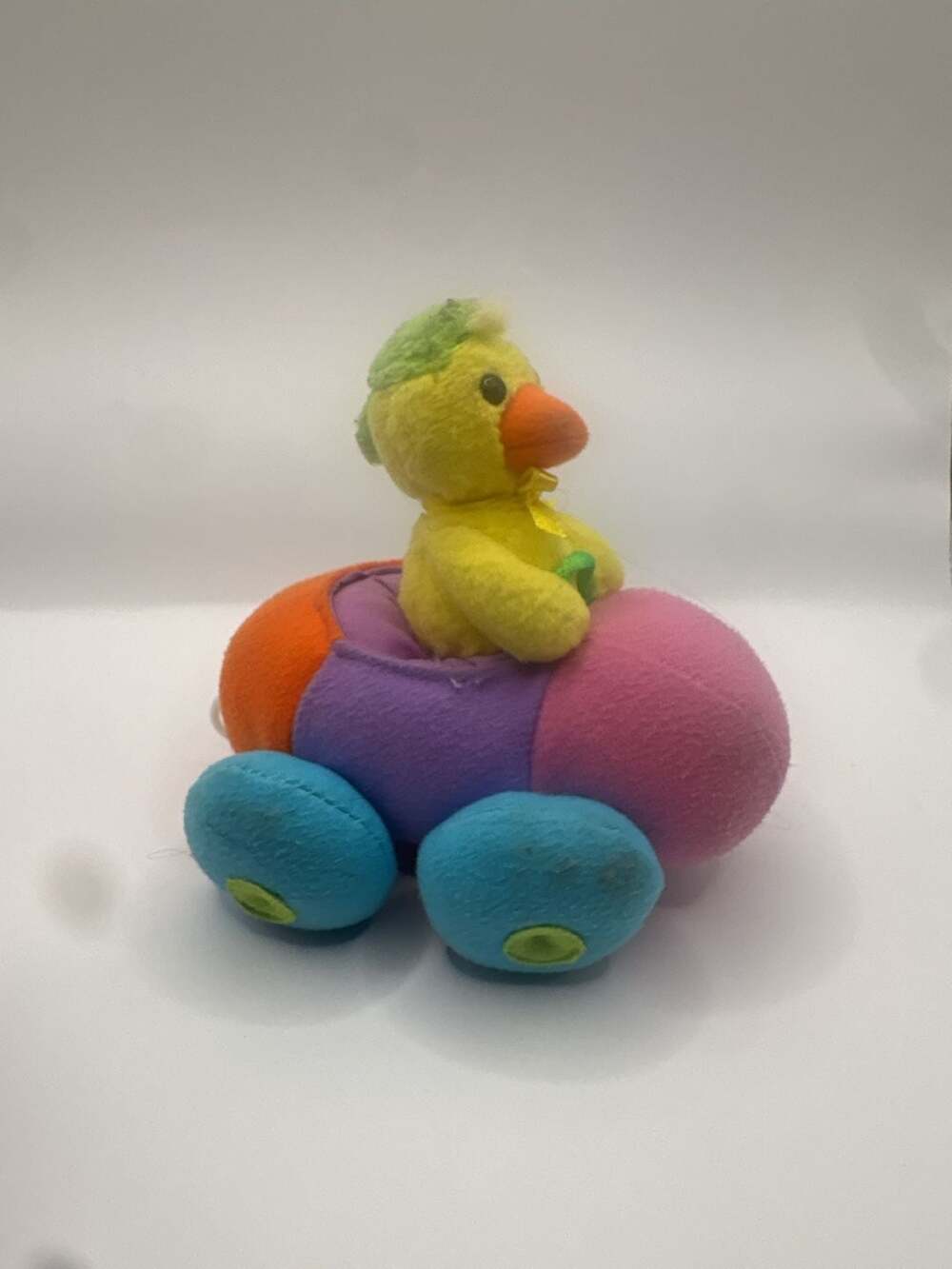 Vintage Pull-Back Toy Chick Driving a Multi-Colored Plush Bumper Car